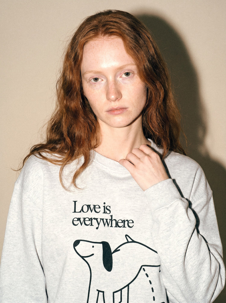 artist collection love is everywhere dog heart design heather grey crewneck sweatshirt female model editorial