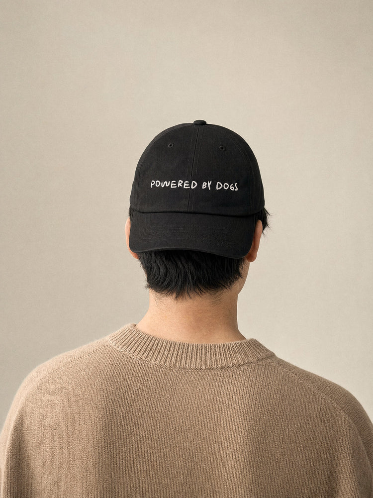 cap powered by dogs black front view east asian man