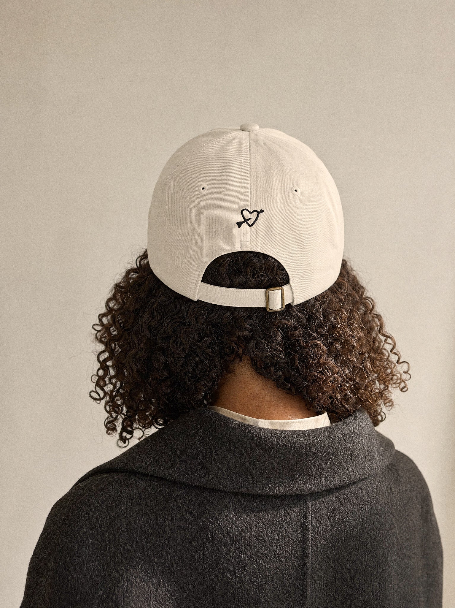 cap powered by dogs oyster back view afro european woman