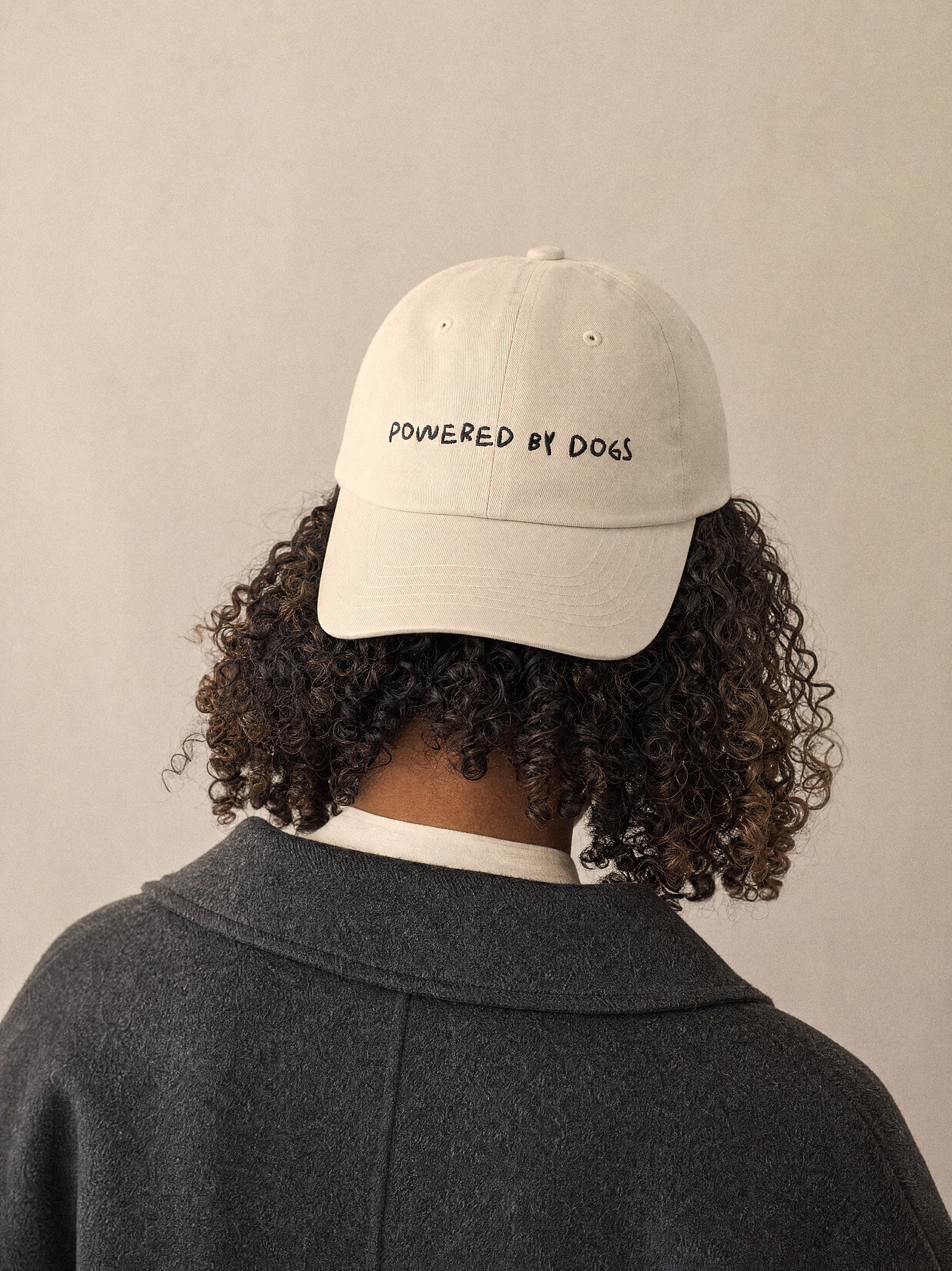 cap powered by dogs oyster front view afro european woman