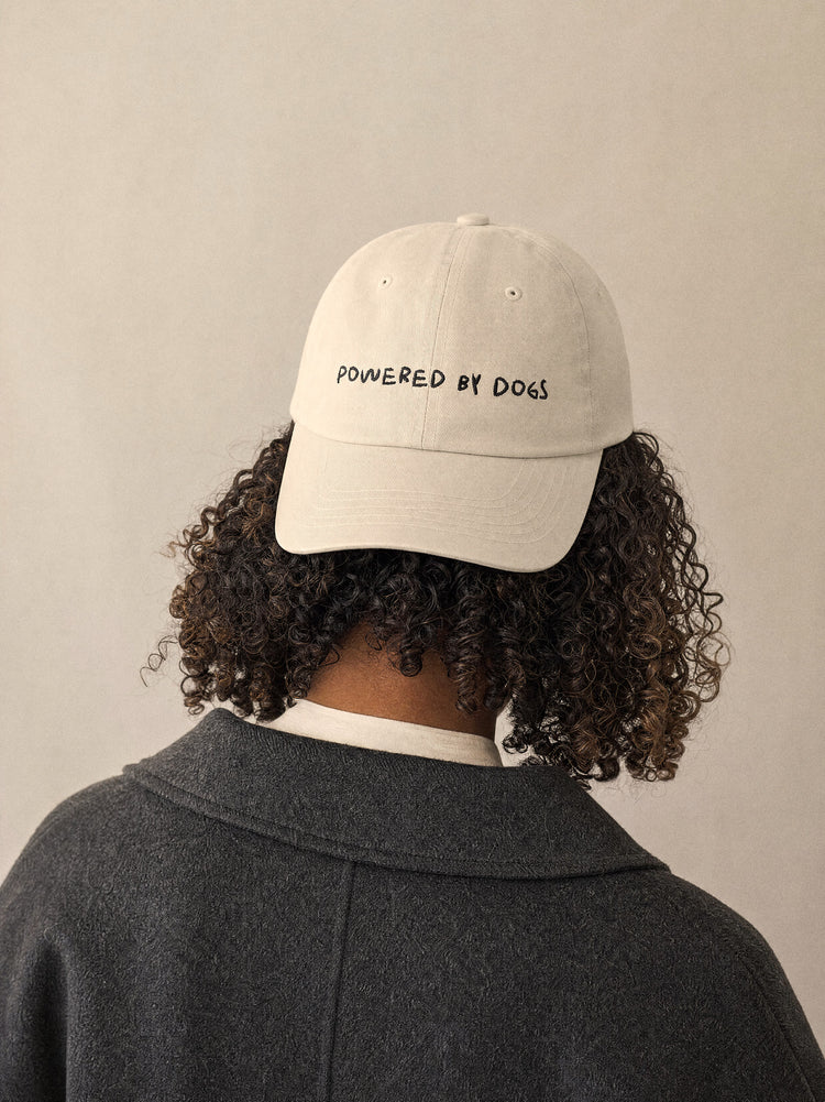 cap powered by dogs oyster front view afro european woman