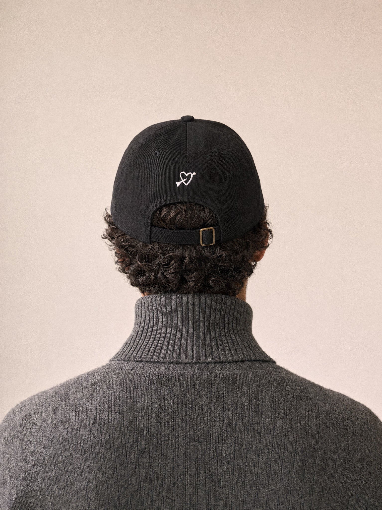 cap you can pet the dog black back view middle eastern man